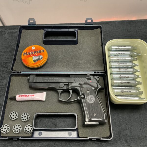 Beretta CO2 pistol with magazines and CO2 cylinders for airgun shooting.