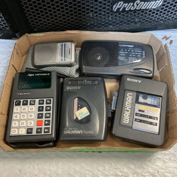 Vintage Sony Walkman lot with calculator, retro audio equipment.