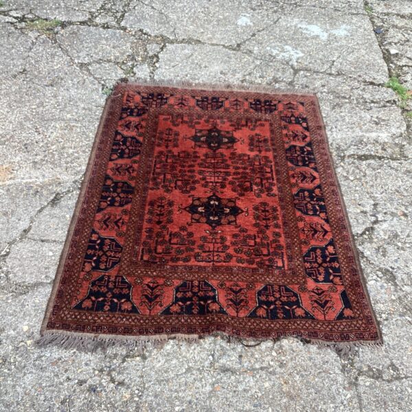 Vintage handmade rug with geometric patterns and rich colours.
