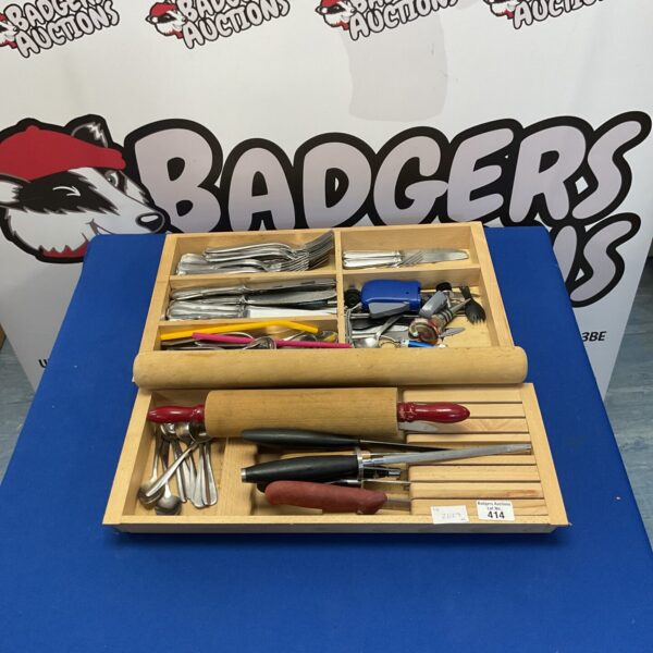 Set of cutlery in wooden drawers