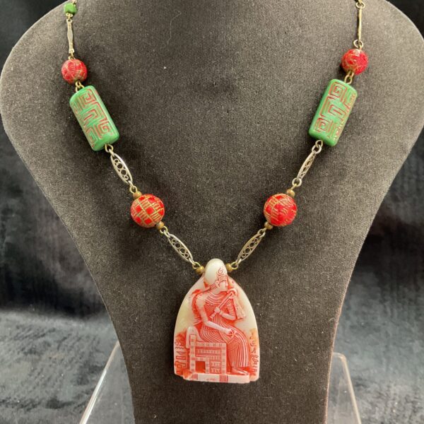 Antique Egyptian carved bead necklace with red beads and stone pendant.