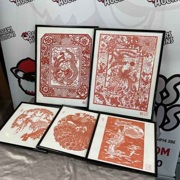 Collection of five detailed Shanghai paper cut artworks on display.