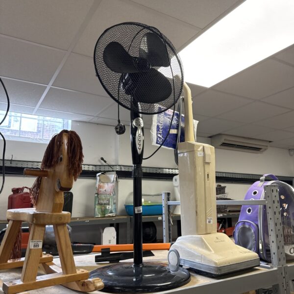 Black vintage pedestal fan with adjustable settings.
