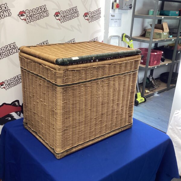 Large wicker basket with woven texture, ideal for storage.
