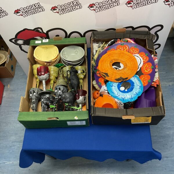 Assorted Halloween decorations in two boxes, spooky festive decor.