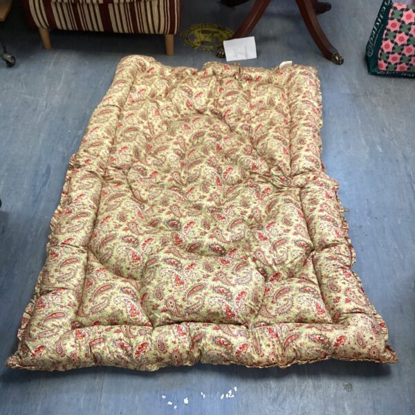 Vintage paisley quilted bedspread with floral pattern.