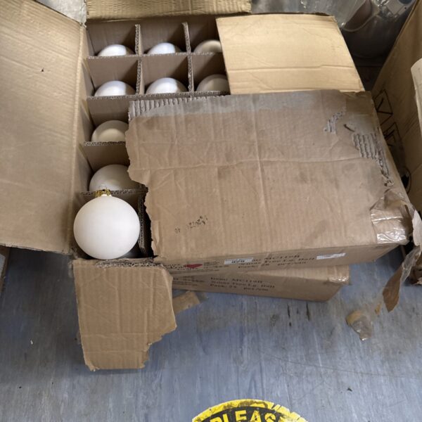 Two boxes of large plastic Christmas tree baubles for festive holiday decor.