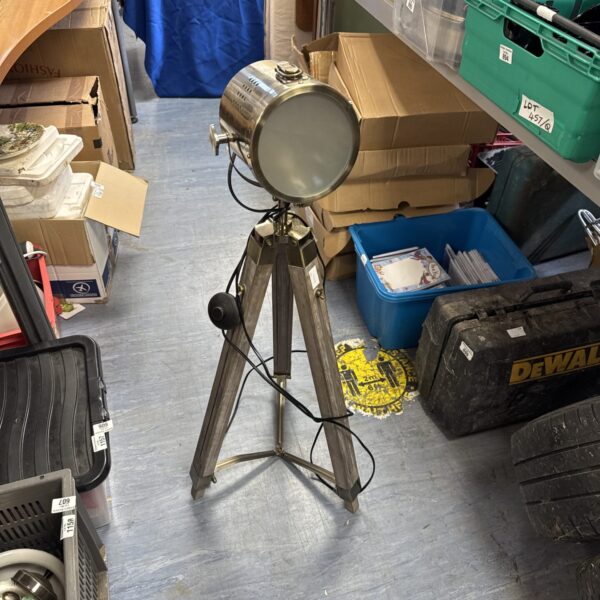 Vintage tripod spotlight with adjustable shade.