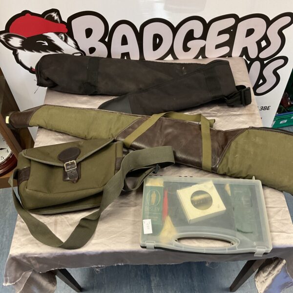 Vintage shooting accessories lot including rifle slips and bag.