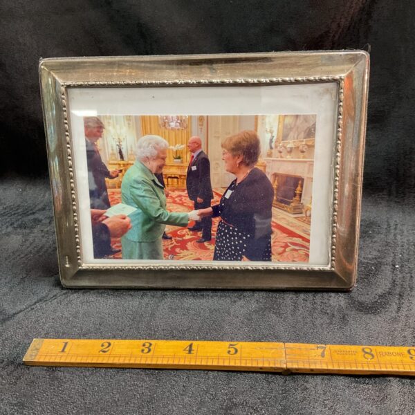 Silver picture frame featuring Queen Elizabeth II photograph.