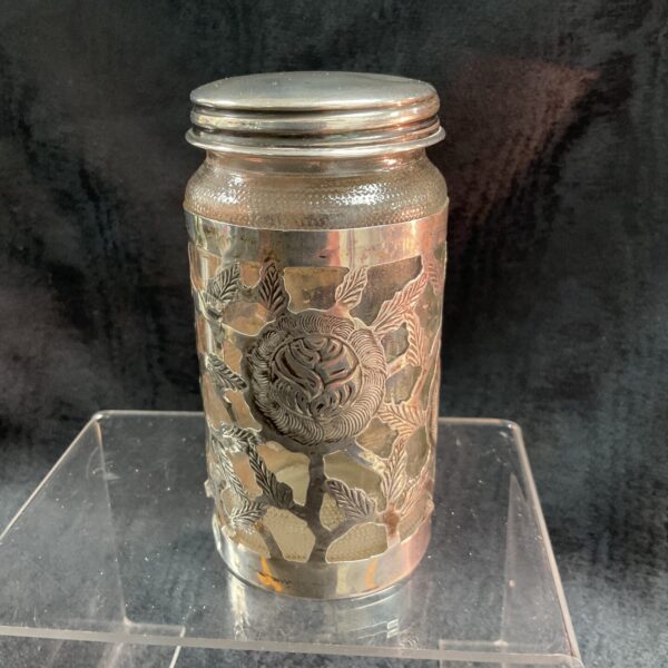 Antique silver lidded jar with floral embossed detailing.