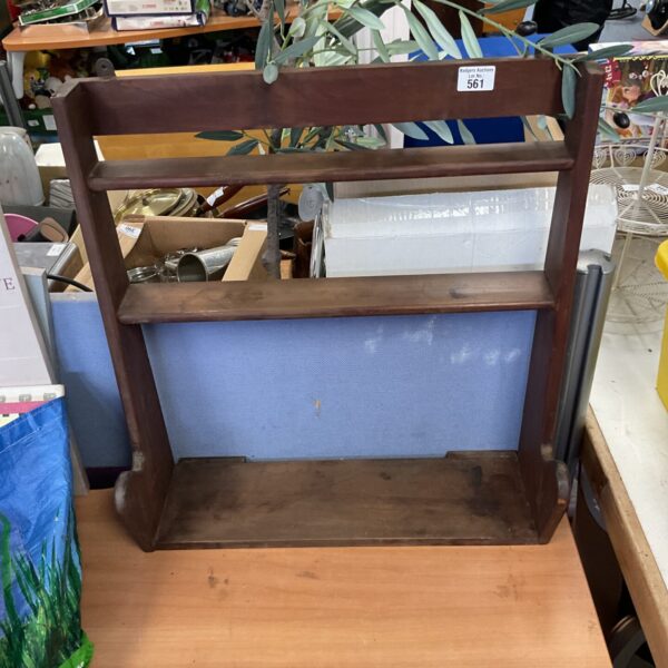 Vintage wooden display rack with tiered shelves for showcasing items.