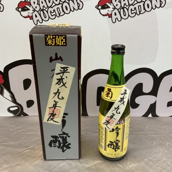Full bottle of Japanese sake with decorative label.