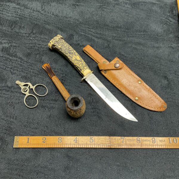 Vintage smoking collectibles set including knife, pipe, and cutter.