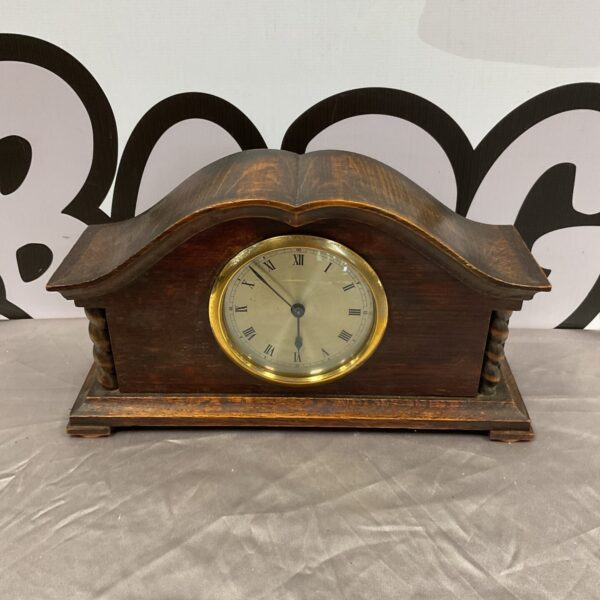 Antique Smith mantle clock with oak case and Roman numerals.