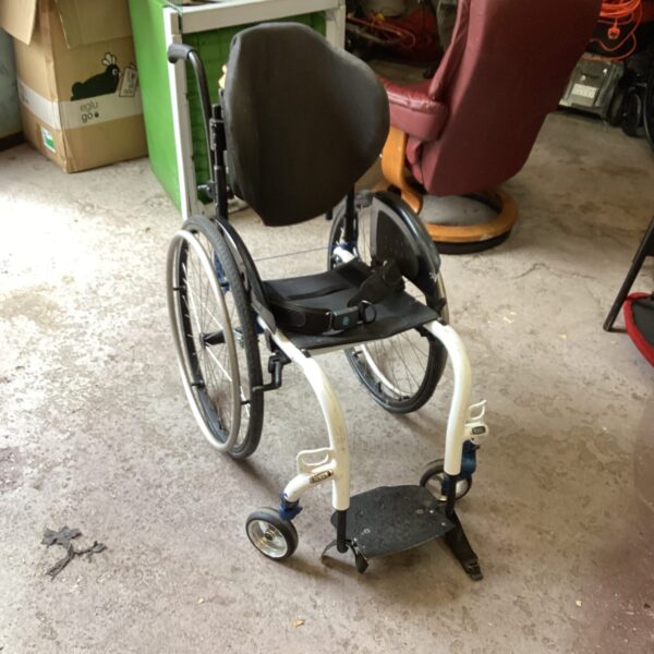 Front view of a high dependency wheelchair with adjustable headrest.