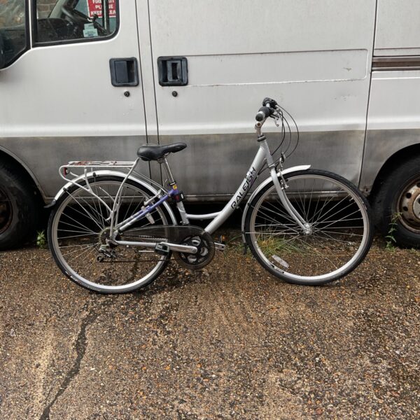Side view of a vintage Raleigh ladies bicycle with a pannier rack.