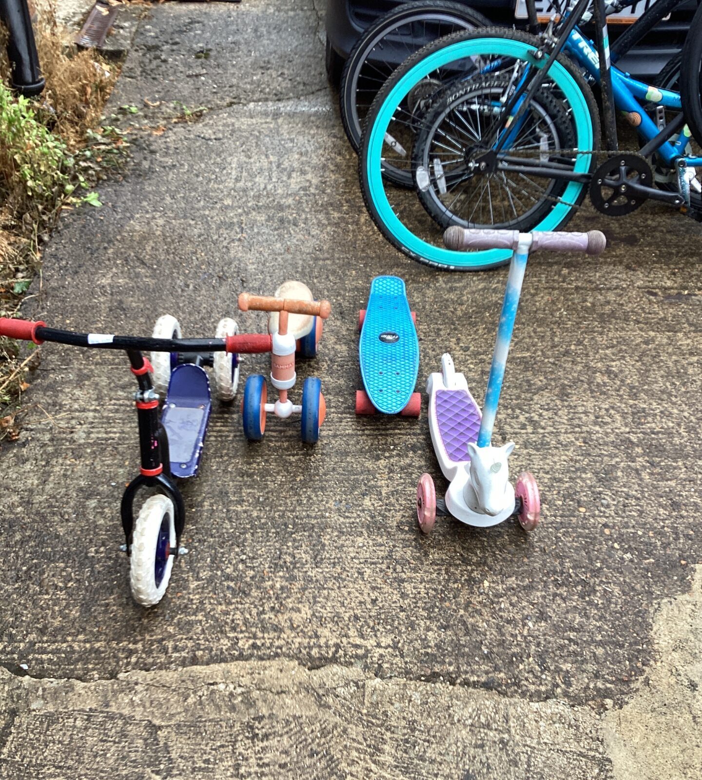 Four childrens bikes and skateboards