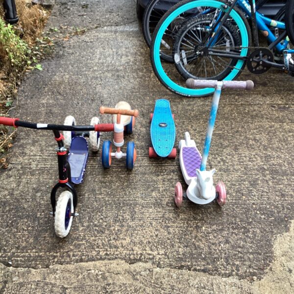 Four childrens bikes and skateboards
