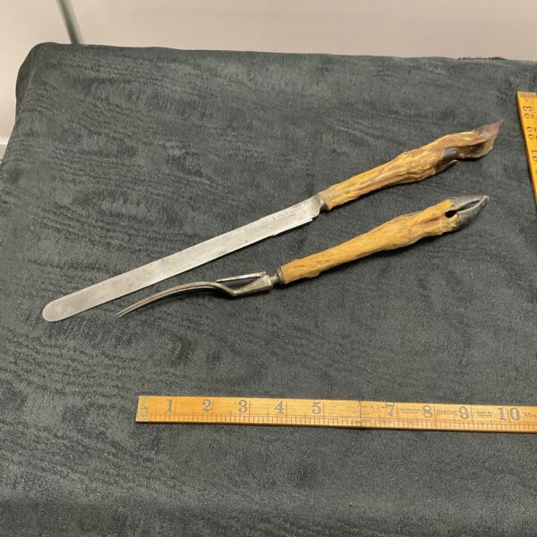 Vintage carving set with unique hoof handle detailing.