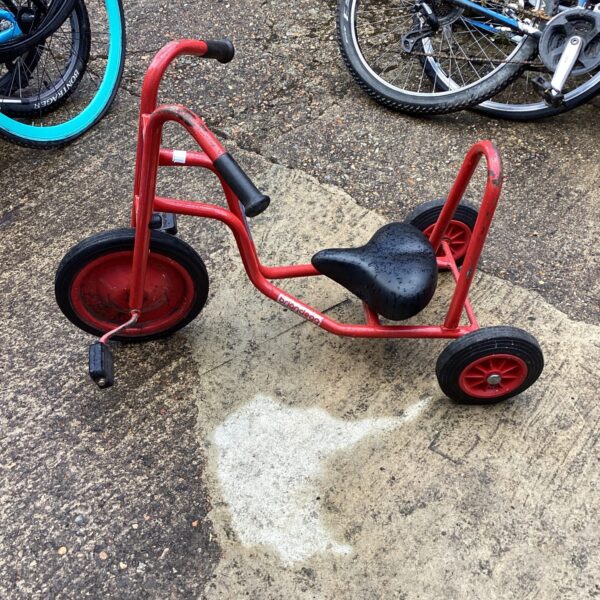Red vintage Brianclegg tricycle, classic children's toy.