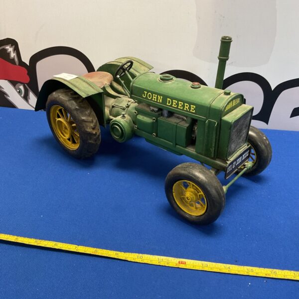 Vintage John Deere tractor model, a collectible farm toy.