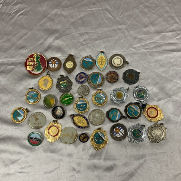 Vintage medal and pin badge collection, historical memorabilia.