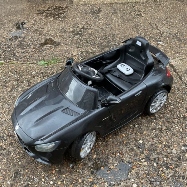 Black Mercedes Benz ride on car for children, remote controlled.