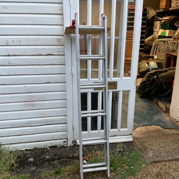 Vintage aluminium decorators ladder leaning against a wall.