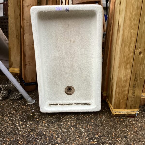 Vintage fireclay Belfast sink with a worn patina.