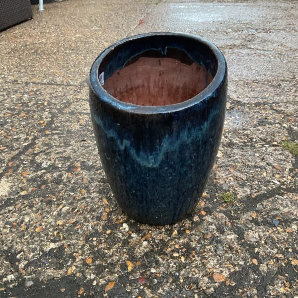 Vibrant blue ceramic plant pot for garden or home decor.