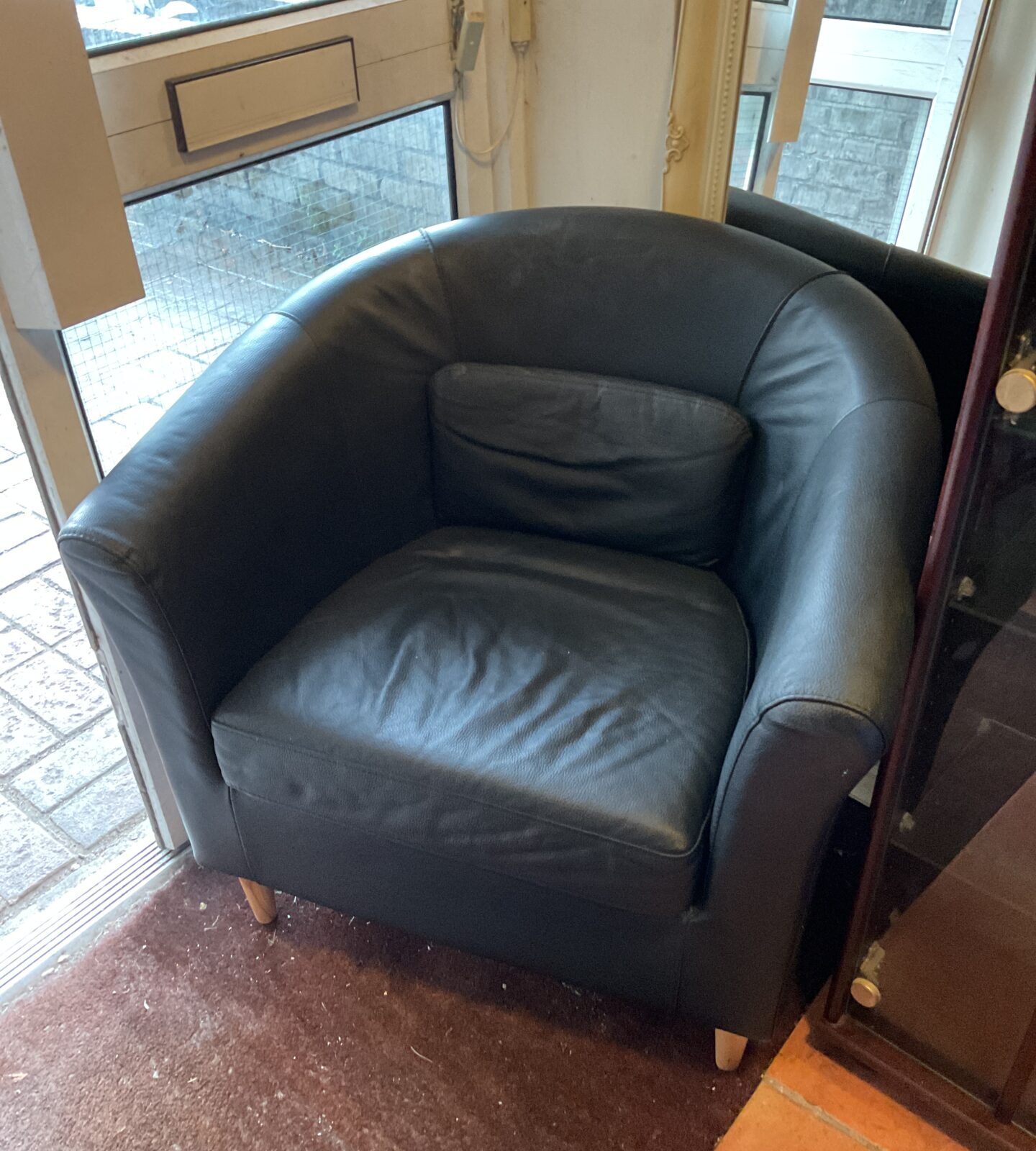 Black leatherette tub chair