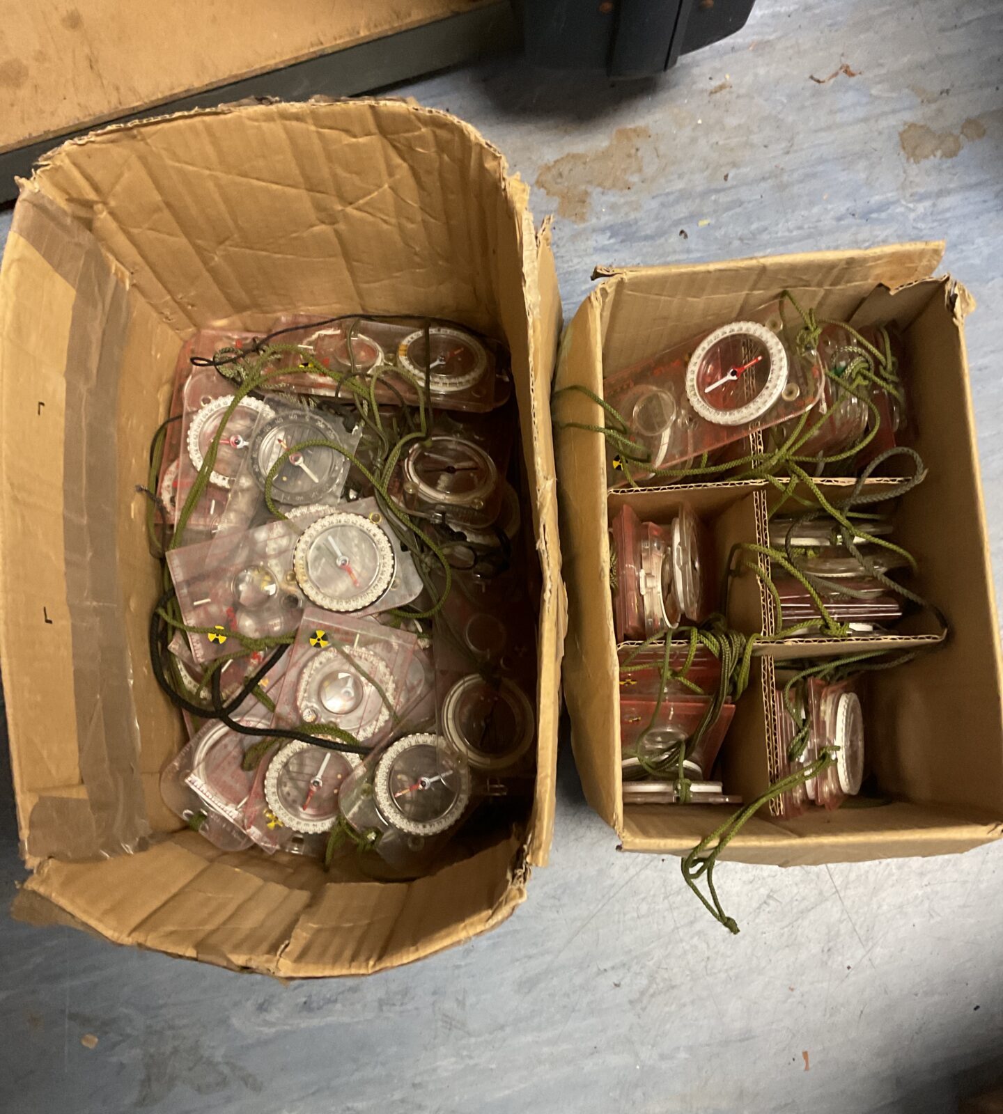 Two boxes full of compasses