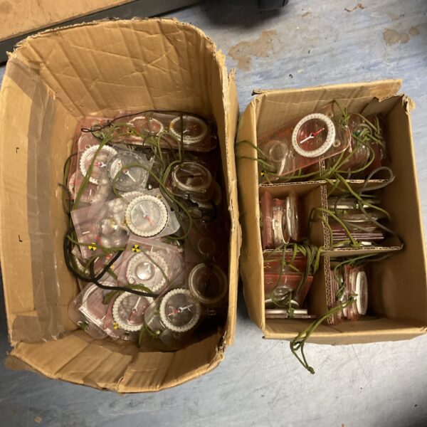 Two boxes full of compasses