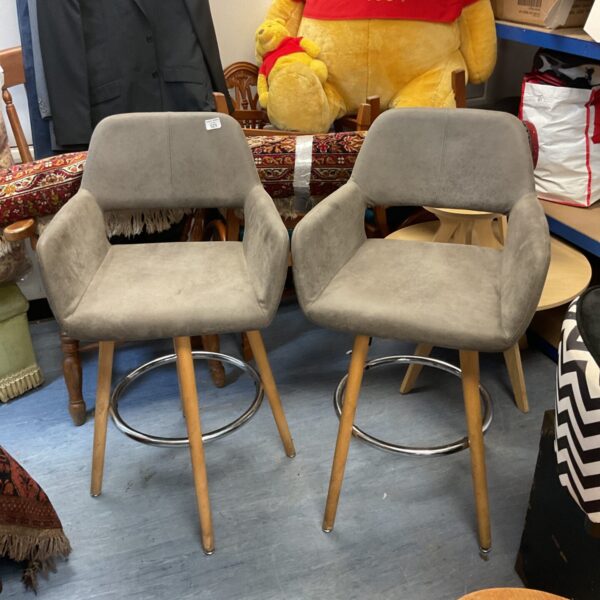 Pair of grey fabric swivel bar stools