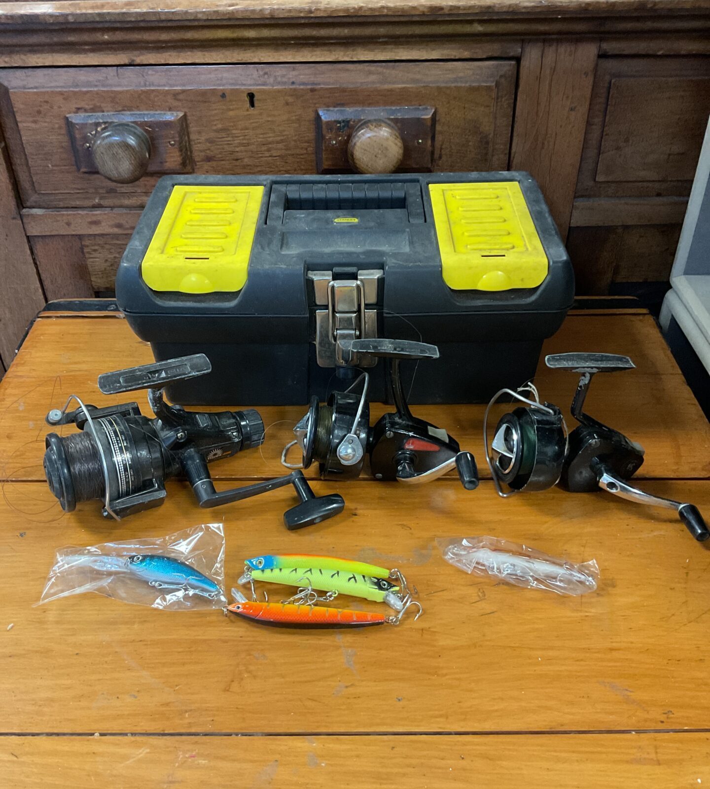 Three fishing reels & selection of lures including daiwa & intrepid
