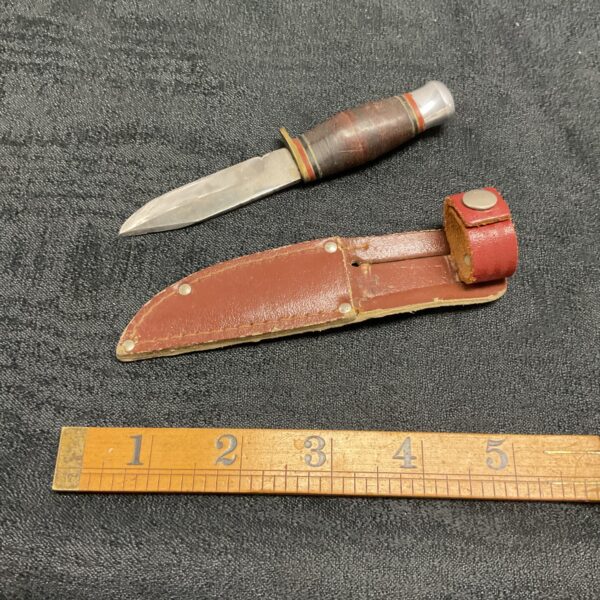 Vintage stack handle sheath knife with leather handle.