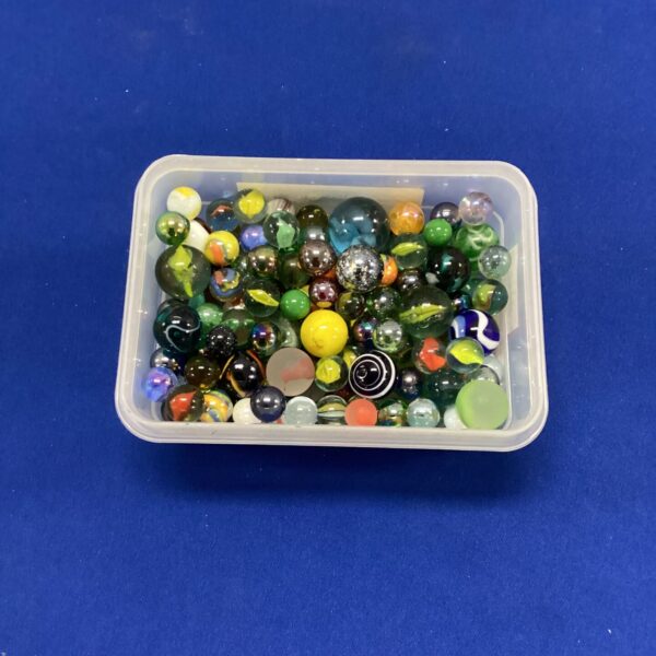 Colourful assortment of glass marbles in a plastic tub.