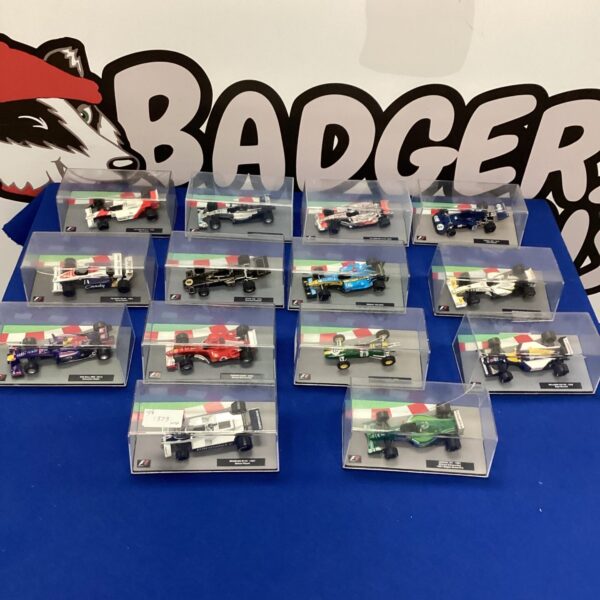 Set of fourteen detailed Formula One model cars in display cases.