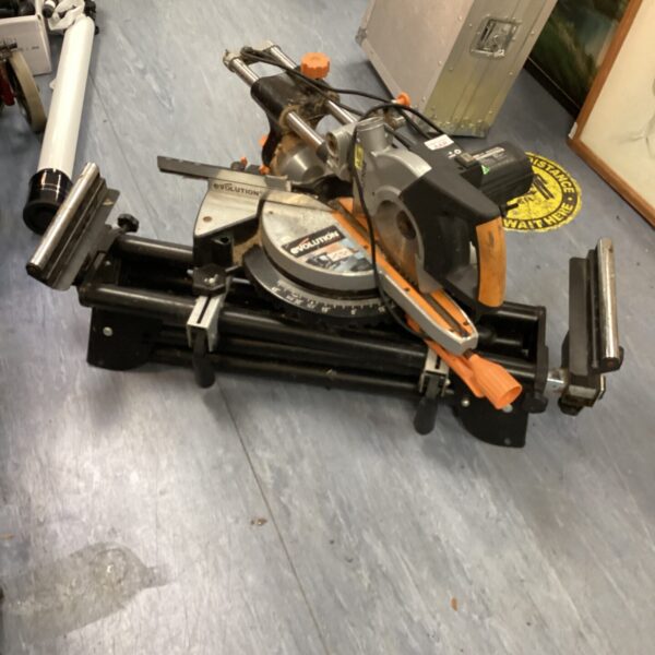 Evolution Rage 3-S300 electric mitre saw with attached bench for woodworking.