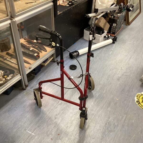 Red Drive folding walker with three wheels for mobility assistance.