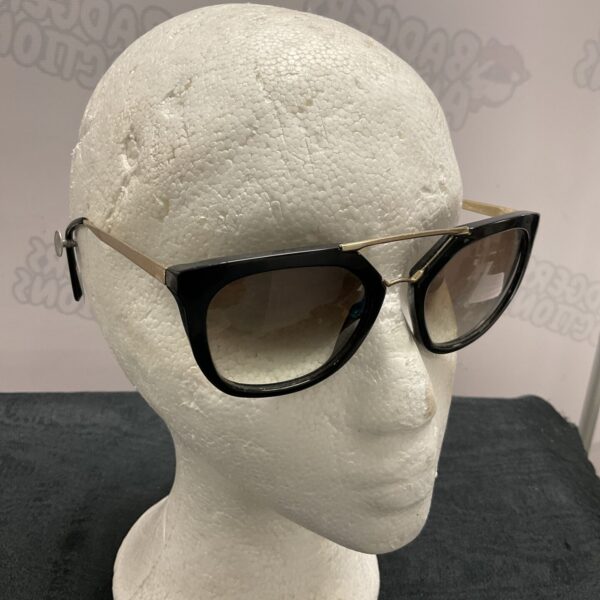 Stylish black Prada sunglasses with gradient brown lenses.