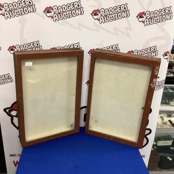 Two vintage glass display cabinets with wooden frames.