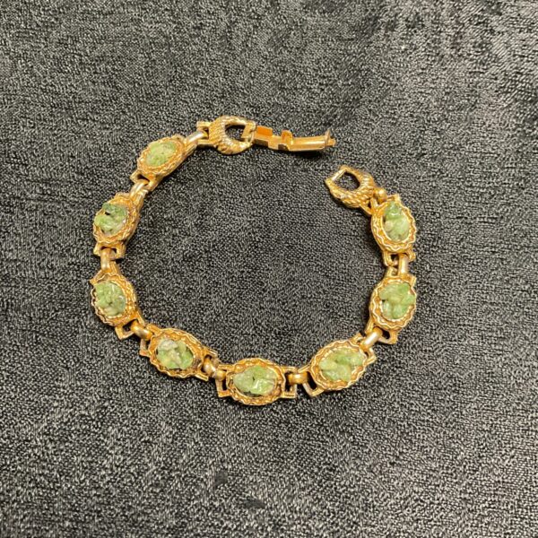 Vintage jade gate bracelet with intricate carvings.