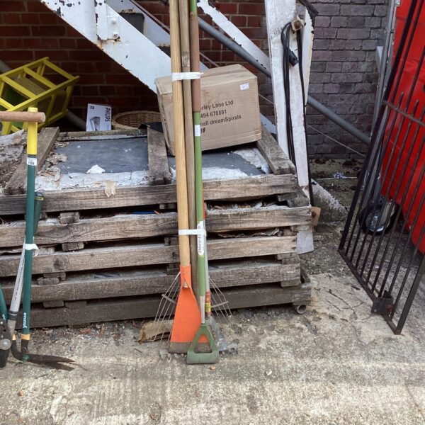 Selection of vintage garden tools including a spade and rake.