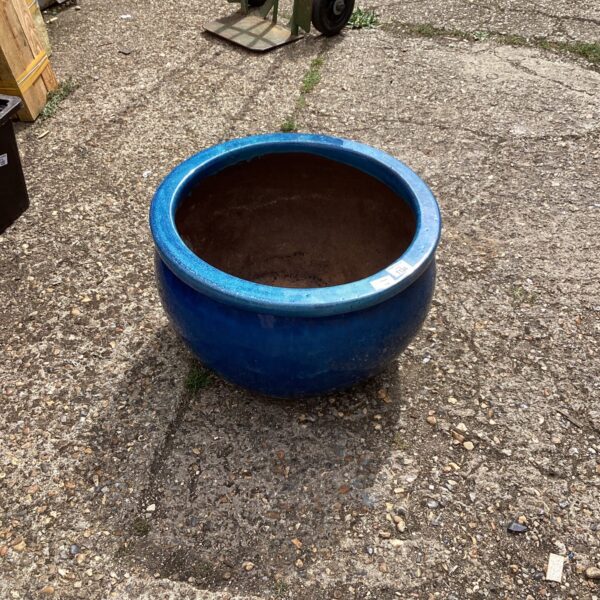 Large blue glazed ceramic garden planter for outdoor plants.