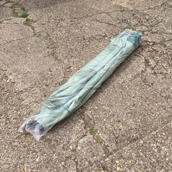 Large garden parasol stored in its protective carrying bag.