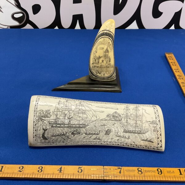 Antique scrimshaw whale tooth on display, detailed carving of a whaler.