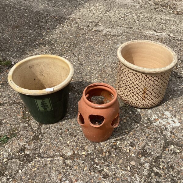 Collection of three vintage garden planters for outdoor use.