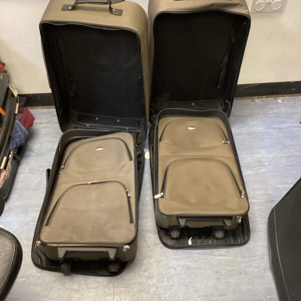Pair of four wheeled suitcases with extendable handles, travel luggage.